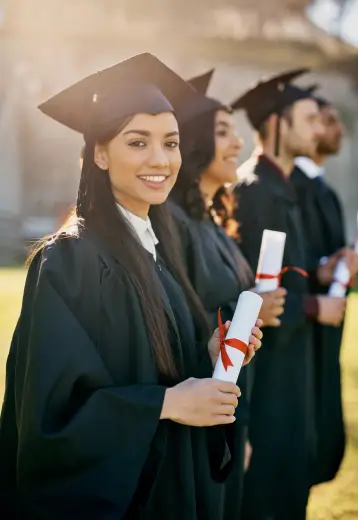 A diverse group of graduates proudly displaying their diplomas, celebrating their academic achievements together.
                        